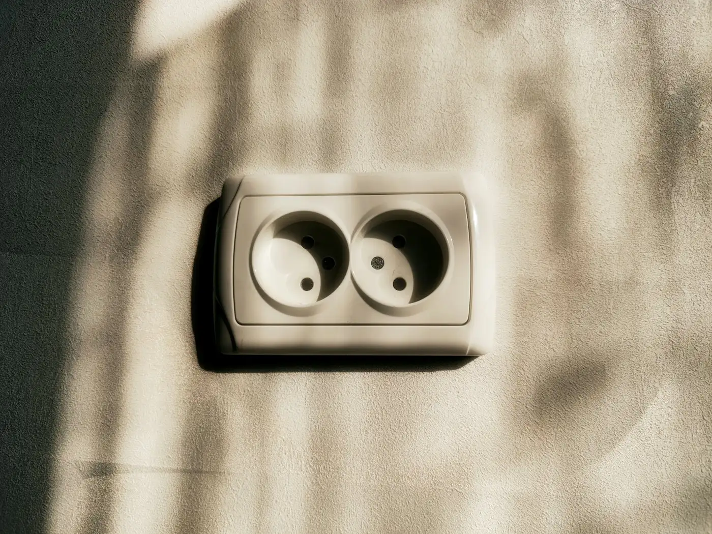 Double electrical socket on a textured wall