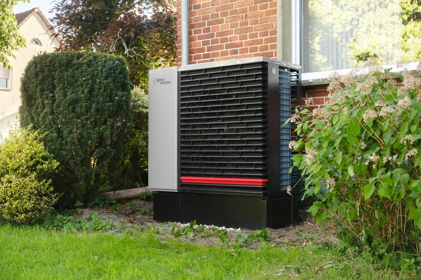 Outdoor heat pump unit next to a brick building