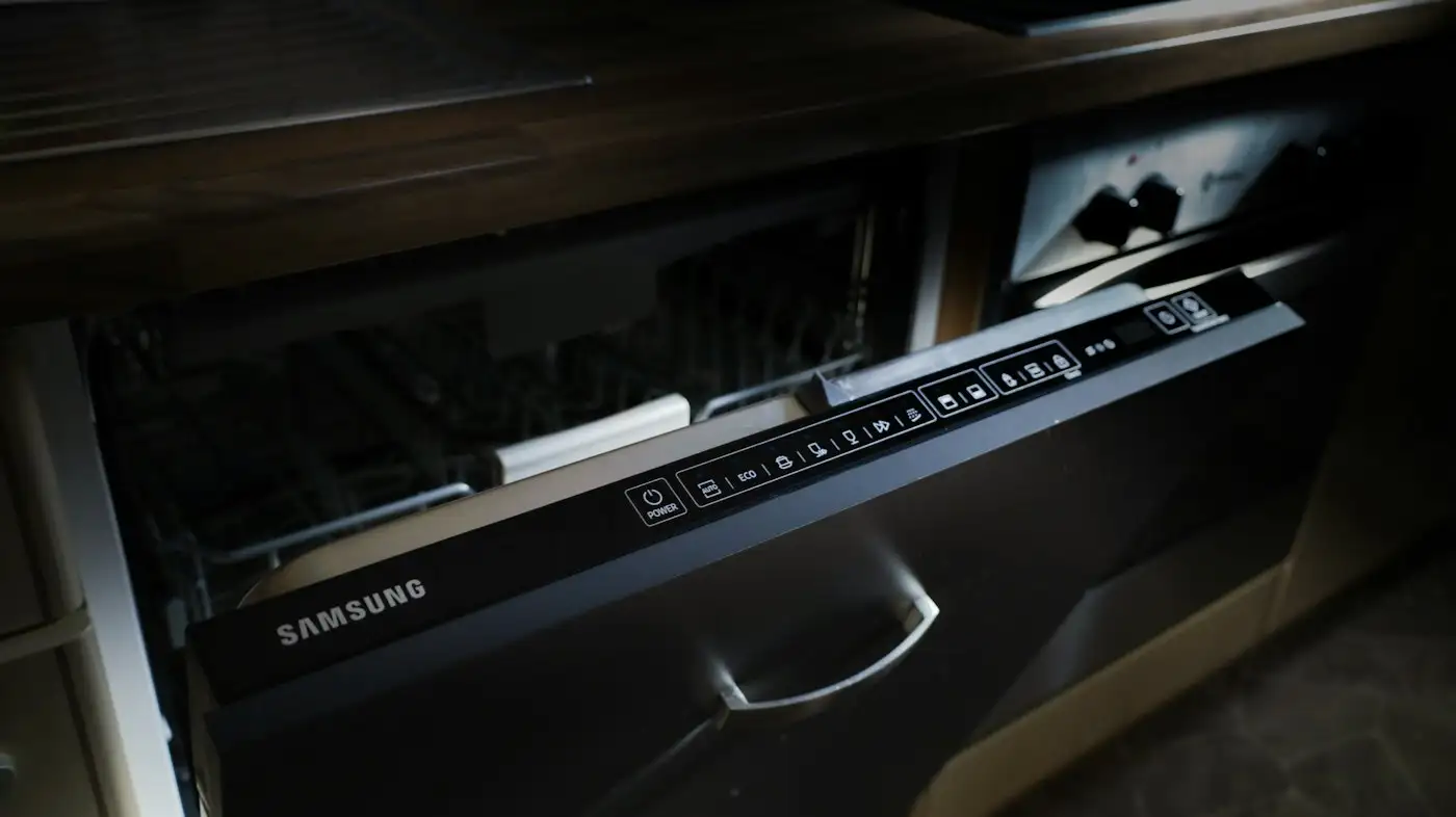 A modern samsung dishwasher drawer built into cabinetry