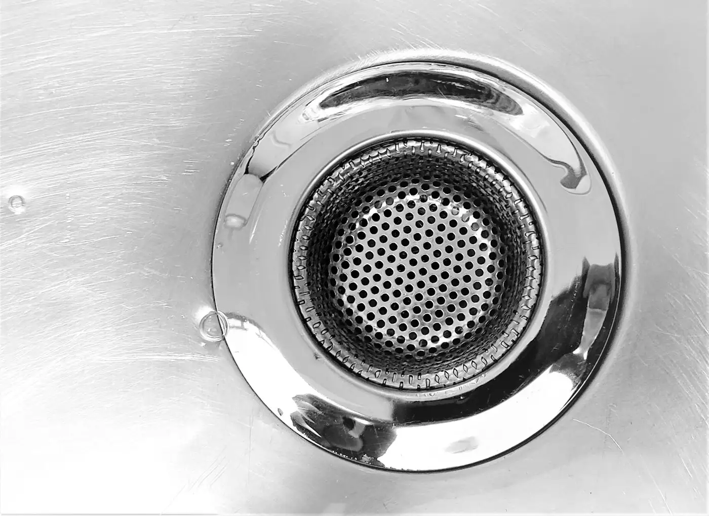 A close up of a metal sink drain