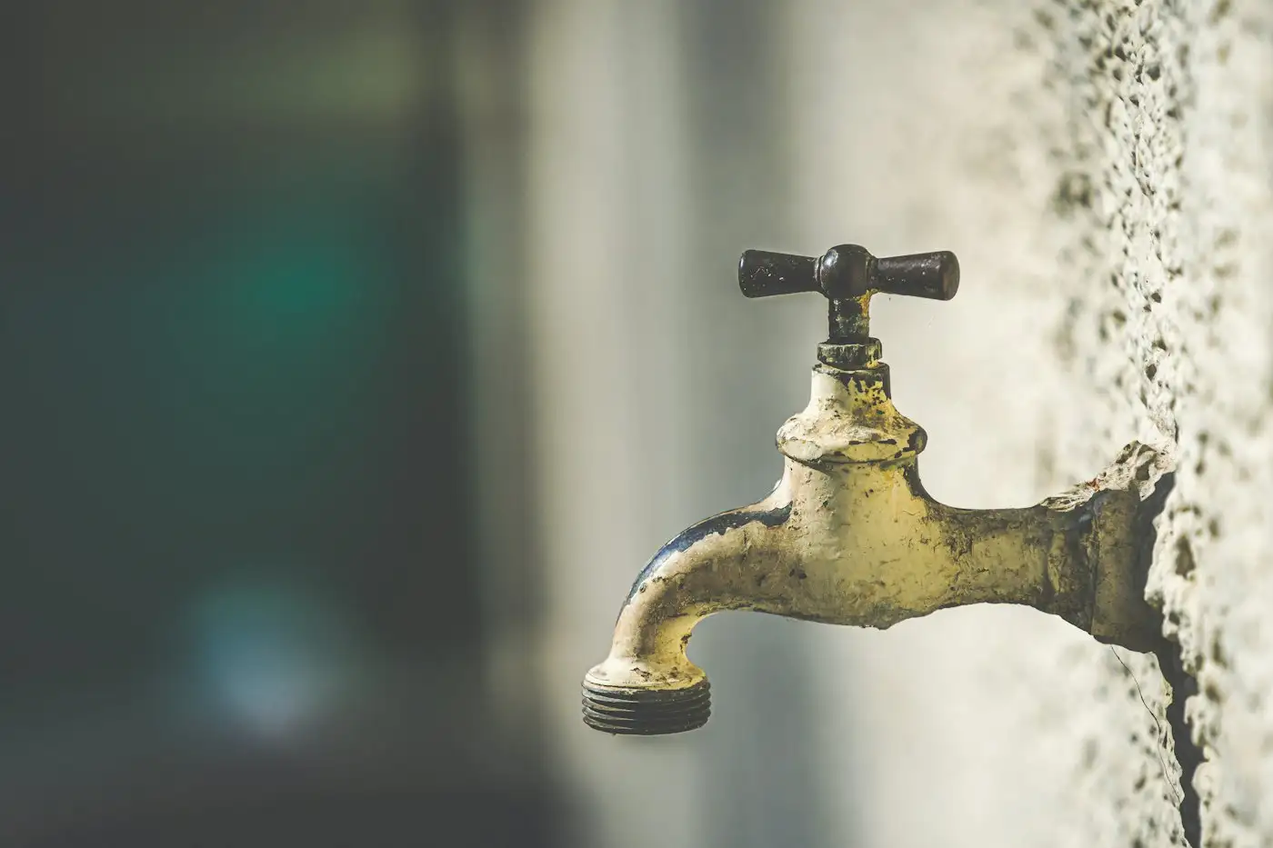 Brass faucet with water droplets