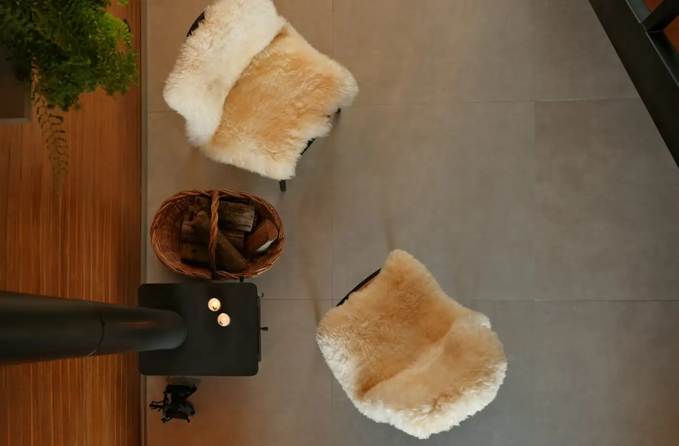 Two fluffy chairs and a basket of wood