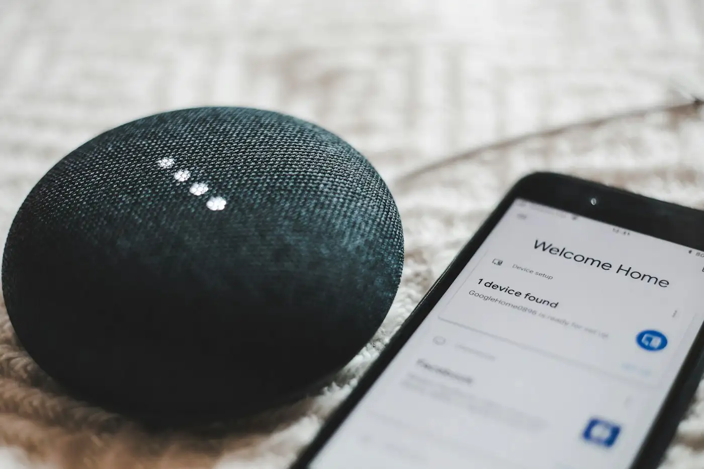 Turned on charcoal google home mini and smartphone
