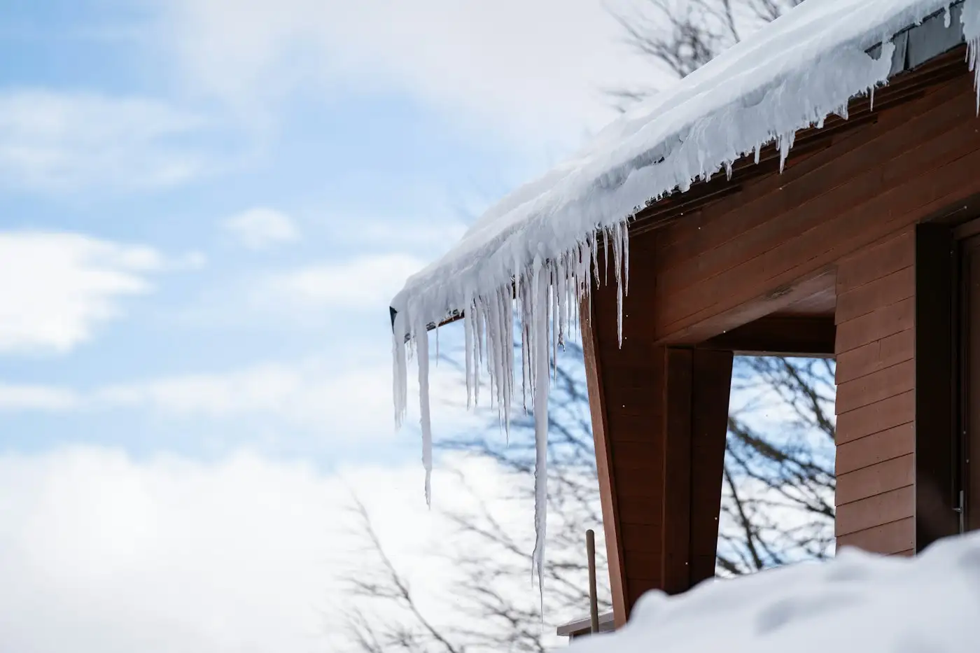 Icicles on snow covered cabin roof