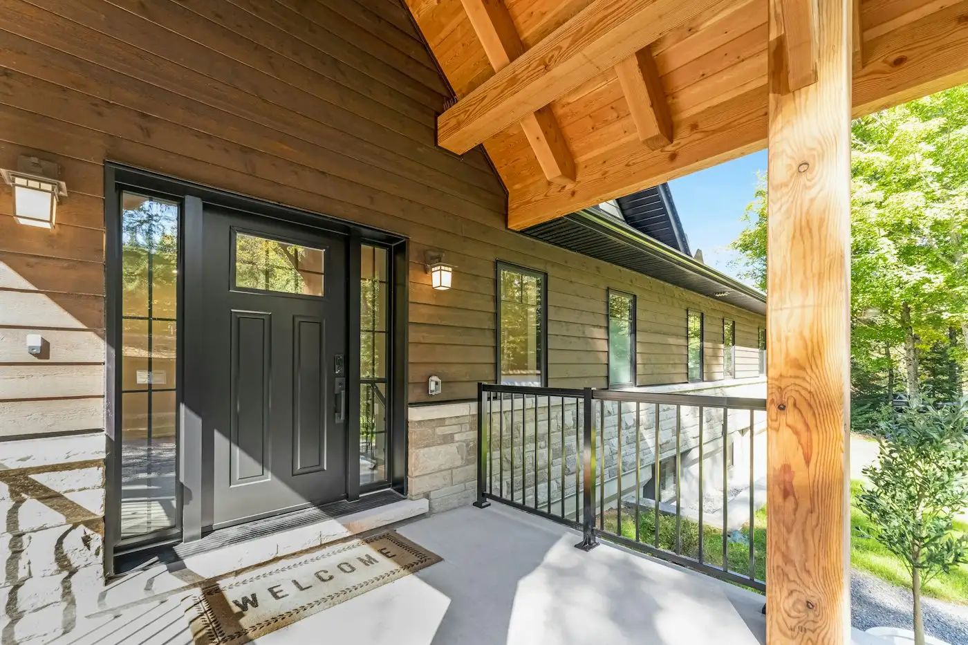Black front door on wooden porch